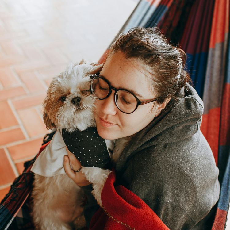 Woman hugging small dog